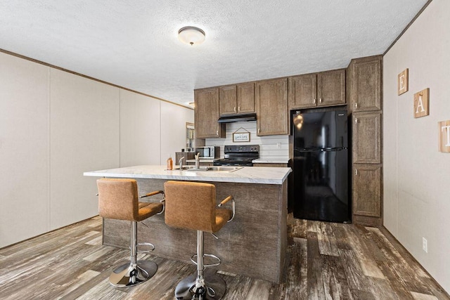 4711 Walnut Rd Lot K-5, Buckeye Lake, OH 43008 - kitchen featuring light countertops, freestanding refrigerator, dark wood-style floors, and range