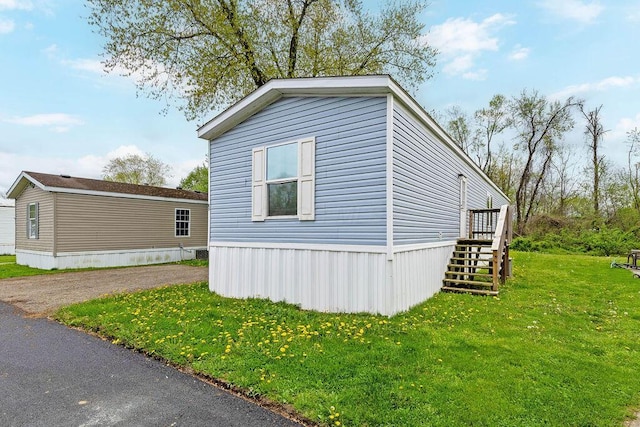 4711 Walnut Rd Lot K-5, Buckeye Lake, OH 43008 - view of side of home featuring a lawn and stairway