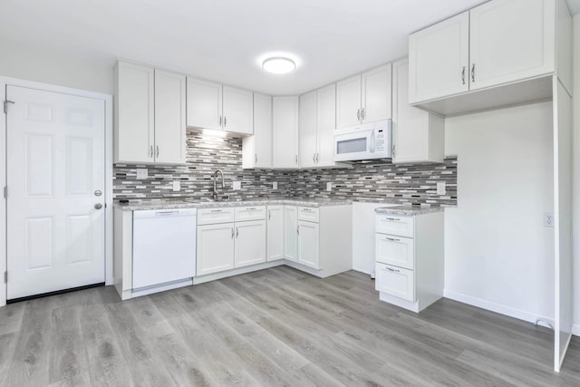 311 Williamsburg Ln NW, Lancaster, OH 43130 - kitchen with white appliances, backsplash, a sink, and light wood finished floors
