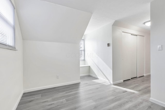 311 Williamsburg Ln NW, Lancaster, OH 43130 - bonus room with baseboards, wood finished floors, a healthy amount of sunlight, and vaulted ceiling