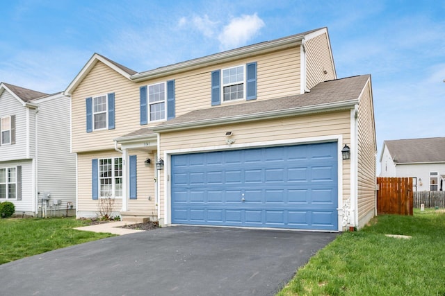3141 Amberfield Dr, Columbus, OH 43232 - view of front facade with fence, an attached garage, driveway, and a front yard