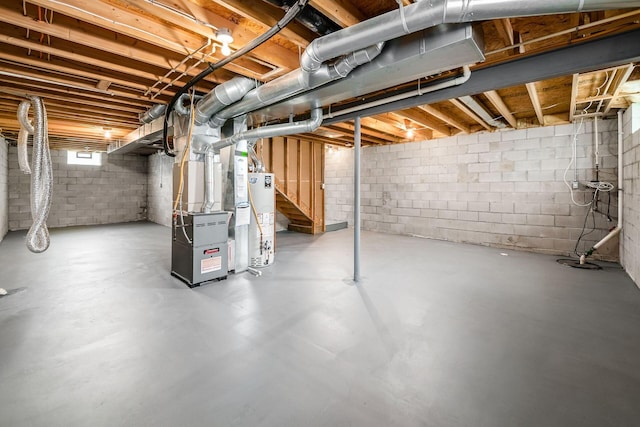 3141 Amberfield Dr, Columbus, OH 43232 - below grade area with heating unit, gas water heater, and stairs