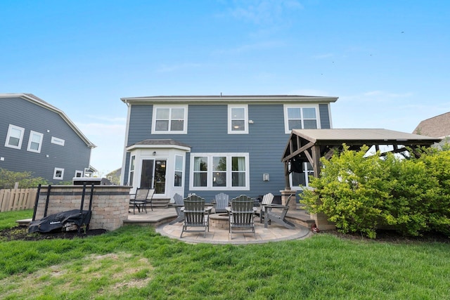 rear view of house with a lawn, fence, and a patio area