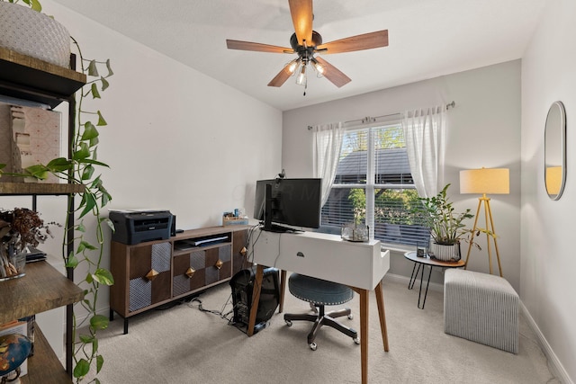 home office with baseboards, light colored carpet, and ceiling fan