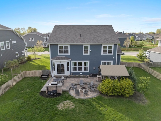 rear view of property featuring a patio, a lawn, a residential view, and an outdoor fire pit
