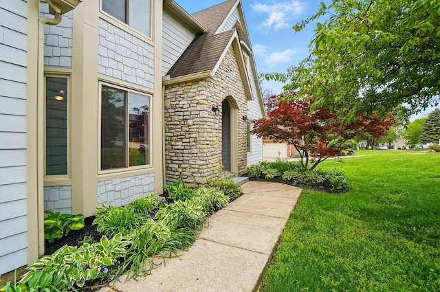 9127 Red Cedar Dr, West Chester, OH 45069 - view of property exterior with roof with shingles, a yard, and stone siding