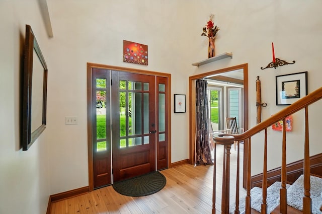 9127 Red Cedar Dr, West Chester, OH 45069 - foyer entrance featuring baseboards, light wood-type flooring, a towering ceiling, and stairs