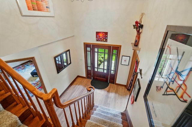 9127 Red Cedar Dr, West Chester, OH 45069 - entryway with stairs, baseboards, wood finished floors, and a towering ceiling