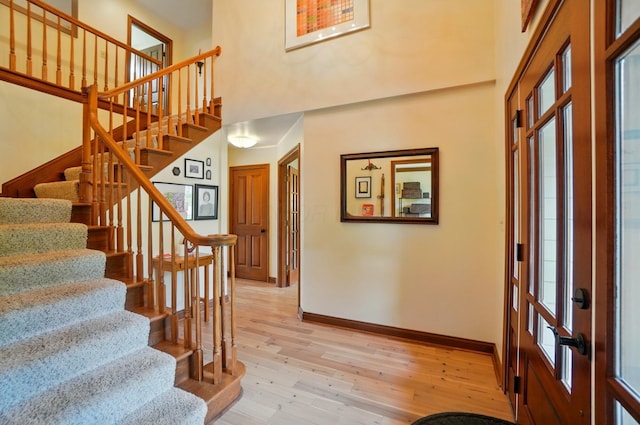 9127 Red Cedar Dr, West Chester, OH 45069 - interior space featuring baseboards, stairs, light wood-style flooring, and a towering ceiling
