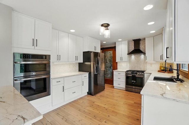 9127 Red Cedar Dr, West Chester, OH 45069 - kitchen with appliances with stainless steel finishes, a sink, wall chimney exhaust hood, and tasteful backsplash