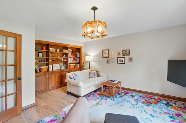 9127 Red Cedar Dr, West Chester, OH 45069 - living room with a chandelier and light wood-style flooring