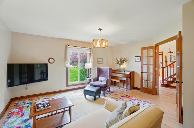 9127 Red Cedar Dr, West Chester, OH 45069 - living area with baseboards, an inviting chandelier, french doors, and light wood-type flooring