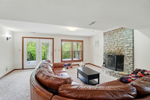 9127 Red Cedar Dr, West Chester, OH 45069 - living area featuring visible vents, baseboards, a stone fireplace, and light carpet