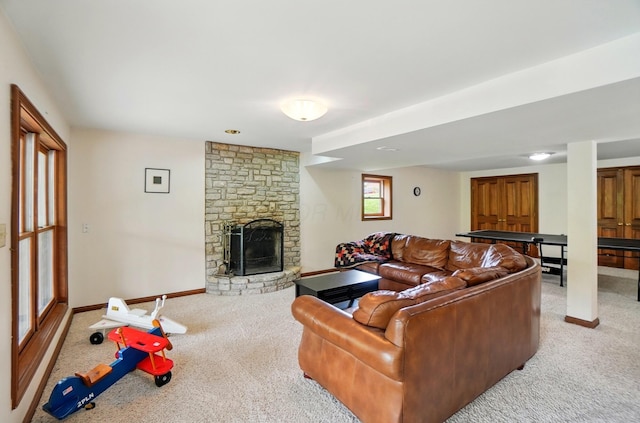 9127 Red Cedar Dr, West Chester, OH 45069 - living area featuring baseboards, a stone fireplace, and light colored carpet