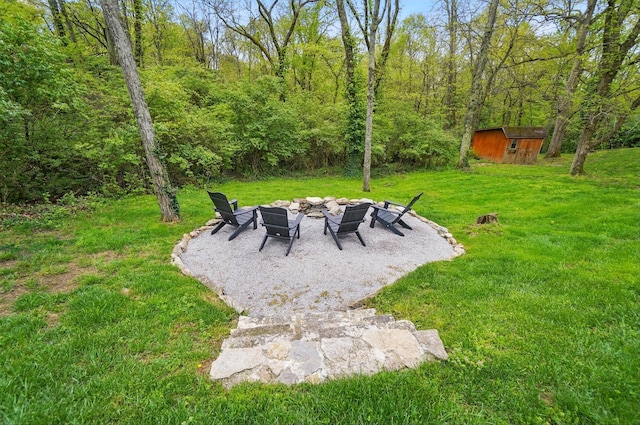 9127 Red Cedar Dr, West Chester, OH 45069 - view of yard featuring a patio, a fire pit, an outdoor structure, and a storage unit