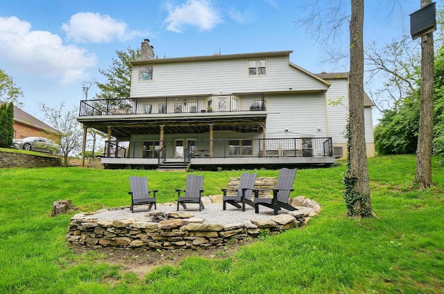 9127 Red Cedar Dr, West Chester, OH 45069 - rear view of property featuring a lawn, a chimney, a fire pit, and a deck