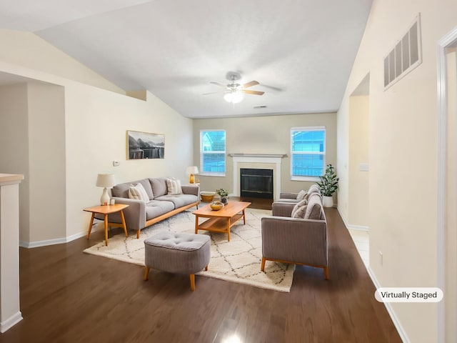 living area featuring visible vents, wood finished floors, lofted ceiling, baseboards, and ceiling fan