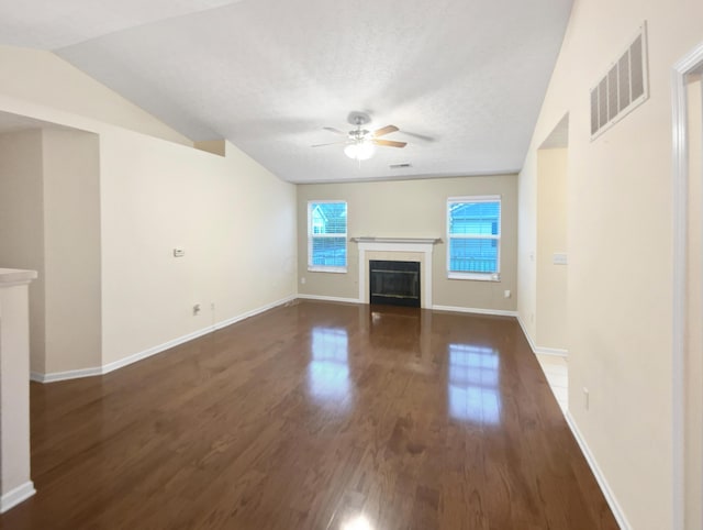 unfurnished living room with ceiling fan, a glass covered fireplace, baseboards, wood finished floors, and visible vents