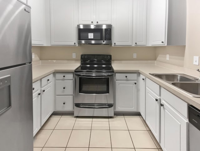 kitchen featuring white cabinets, stainless steel appliances, and a sink