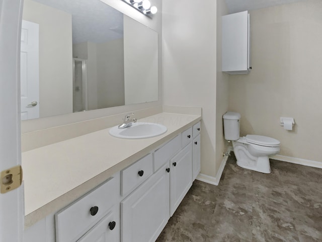 bathroom with vanity, baseboards, toilet, and a shower stall