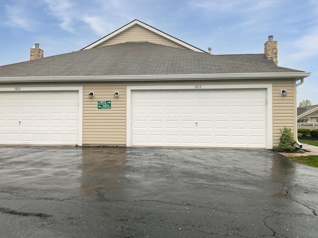 garage with aphalt driveway