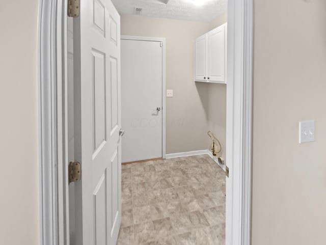 washroom with baseboards