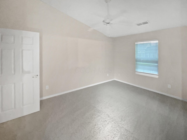 empty room featuring a ceiling fan, baseboards, visible vents, and vaulted ceiling