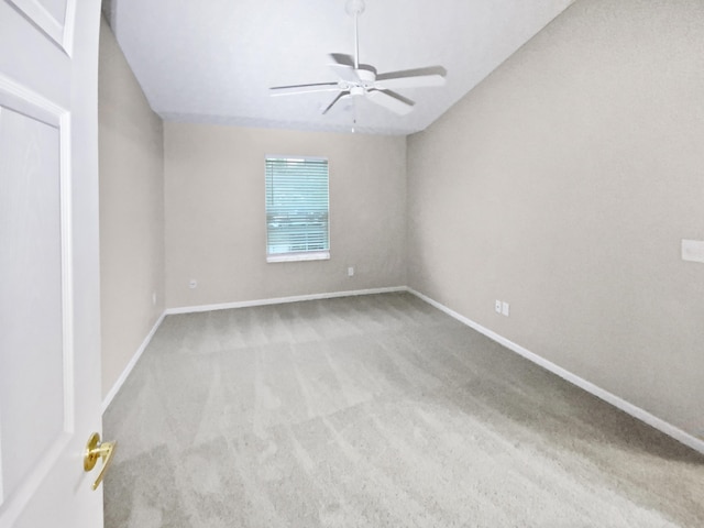 spare room with baseboards, a ceiling fan, and carpet