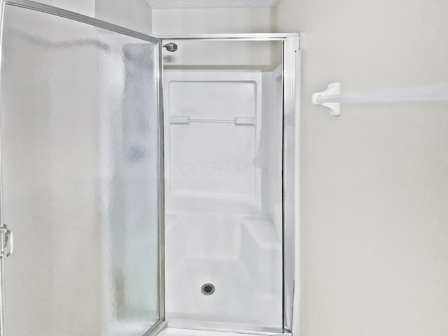 full bath with a shower stall