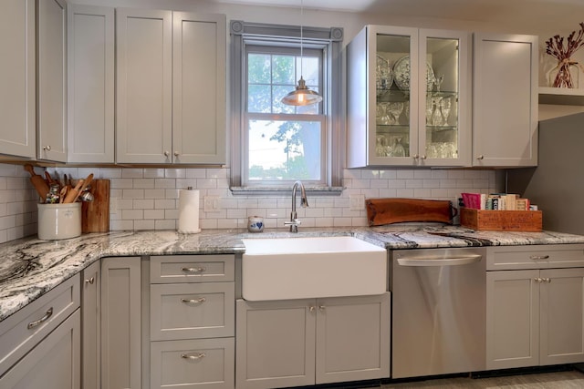 kitchen with a sink, glass insert cabinets, decorative backsplash, and stainless steel dishwasher