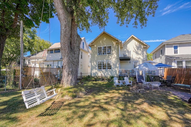 back of house with a fenced backyard and a lawn