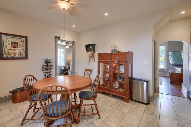 dining space with a ceiling fan, arched walkways, and recessed lighting
