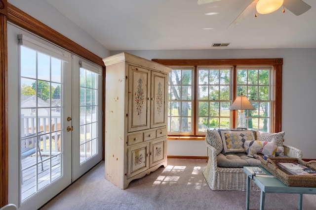 sunroom / solarium with visible vents, plenty of natural light, and french doors