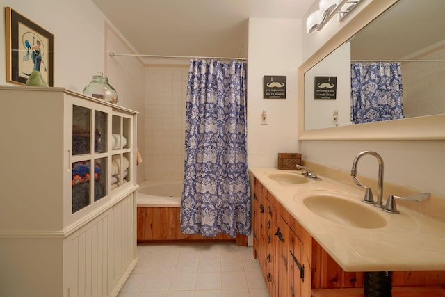bathroom with tile patterned floors, shower / bathtub combination with curtain, and a sink