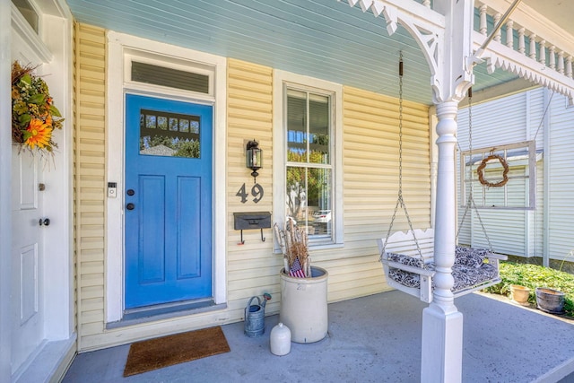 entrance to property featuring covered porch