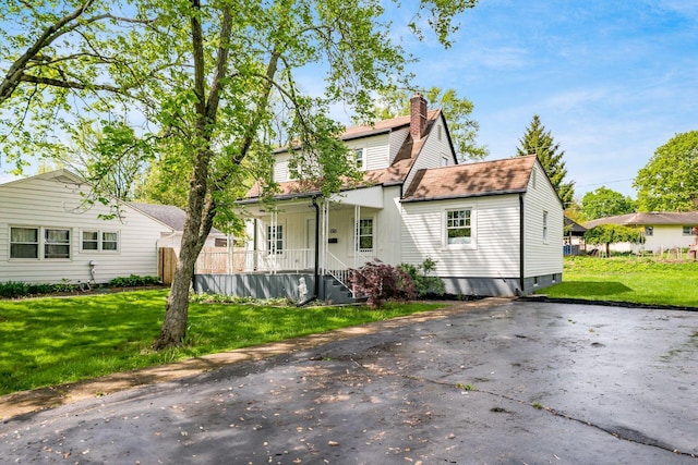 86 Hiawatha Ave, Westerville, OH 43081 - view of front of property featuring covered porch, a chimney, a shingled roof, and a front yard