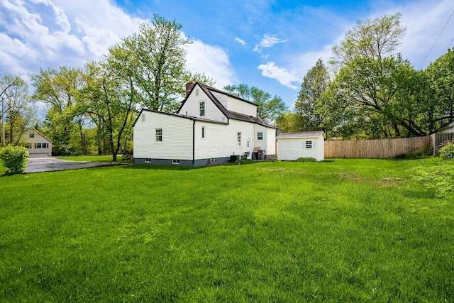 86 Hiawatha Ave, Westerville, OH 43081 - rear view of house with fence, an outbuilding, a yard, and a storage shed