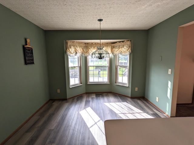 1564 Hocking Valley Pl, Lancaster, OH 43130 - unfurnished dining area featuring wood finished floors, a chandelier, and a textured ceiling