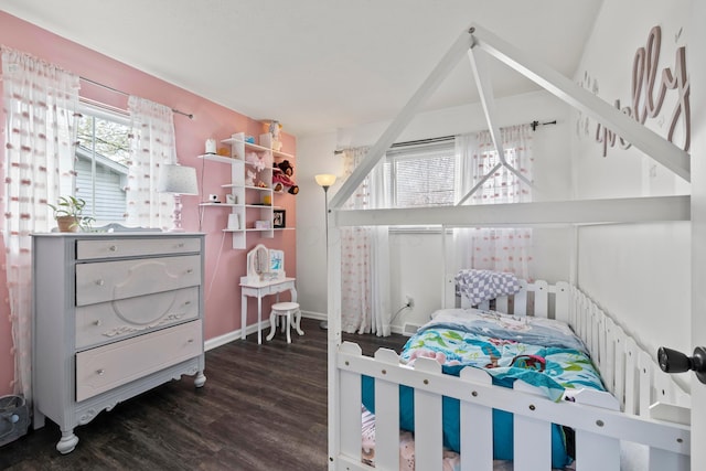 bedroom with baseboards and wood finished floors