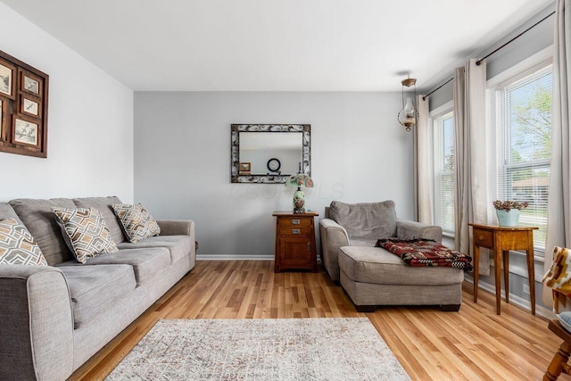living room featuring light wood-type flooring and baseboards