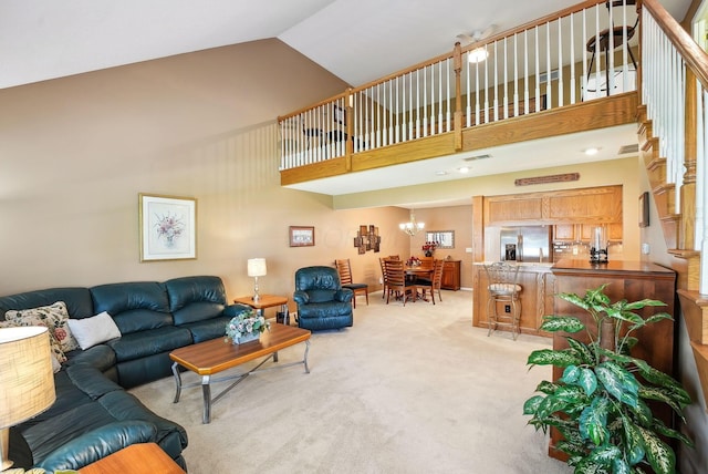 living room featuring stairs, high vaulted ceiling, light colored carpet, and an inviting chandelier