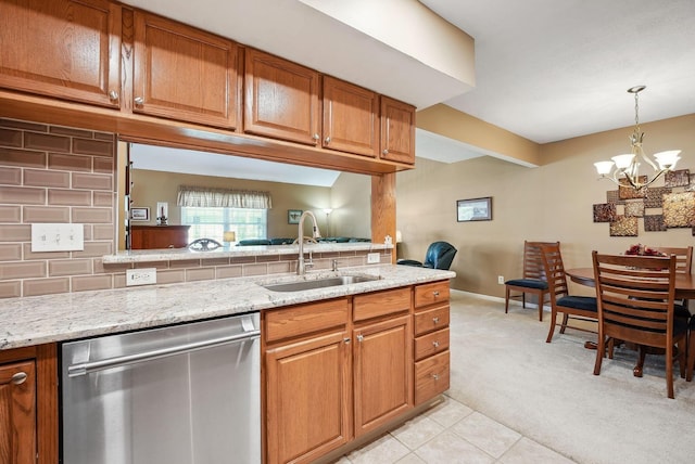 kitchen featuring stainless steel dishwasher, light colored carpet, brown cabinetry, and a sink