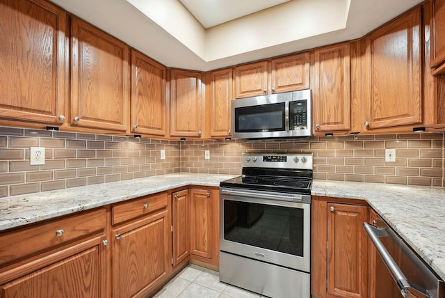 kitchen with appliances with stainless steel finishes and brown cabinets
