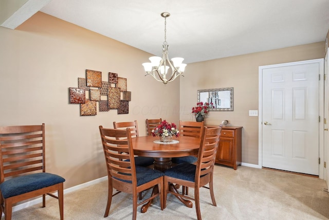 dining area with an inviting chandelier, baseboards, and light carpet