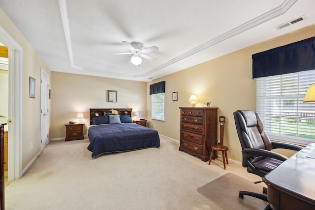carpeted bedroom featuring baseboards, visible vents, ceiling fan, and a raised ceiling