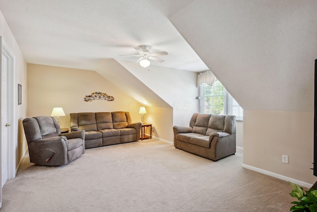 carpeted living room with a ceiling fan, a textured ceiling, vaulted ceiling, and baseboards