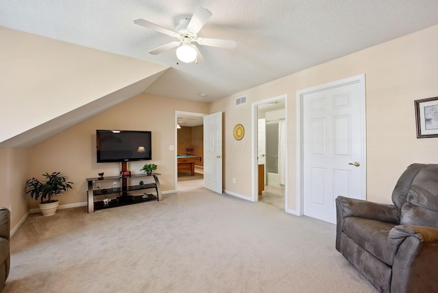 sitting room featuring visible vents, light carpet, baseboards, a ceiling fan, and vaulted ceiling