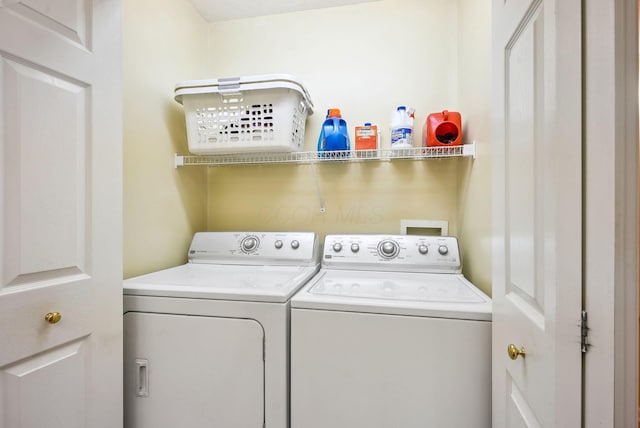 washroom featuring separate washer and dryer and laundry area