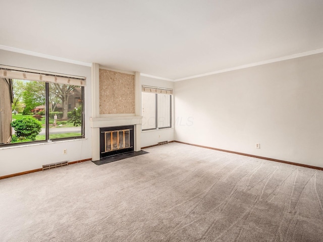 unfurnished living room featuring crown molding, carpet floors, baseboards, and visible vents