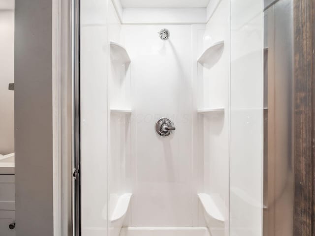bathroom featuring vanity and a stall shower